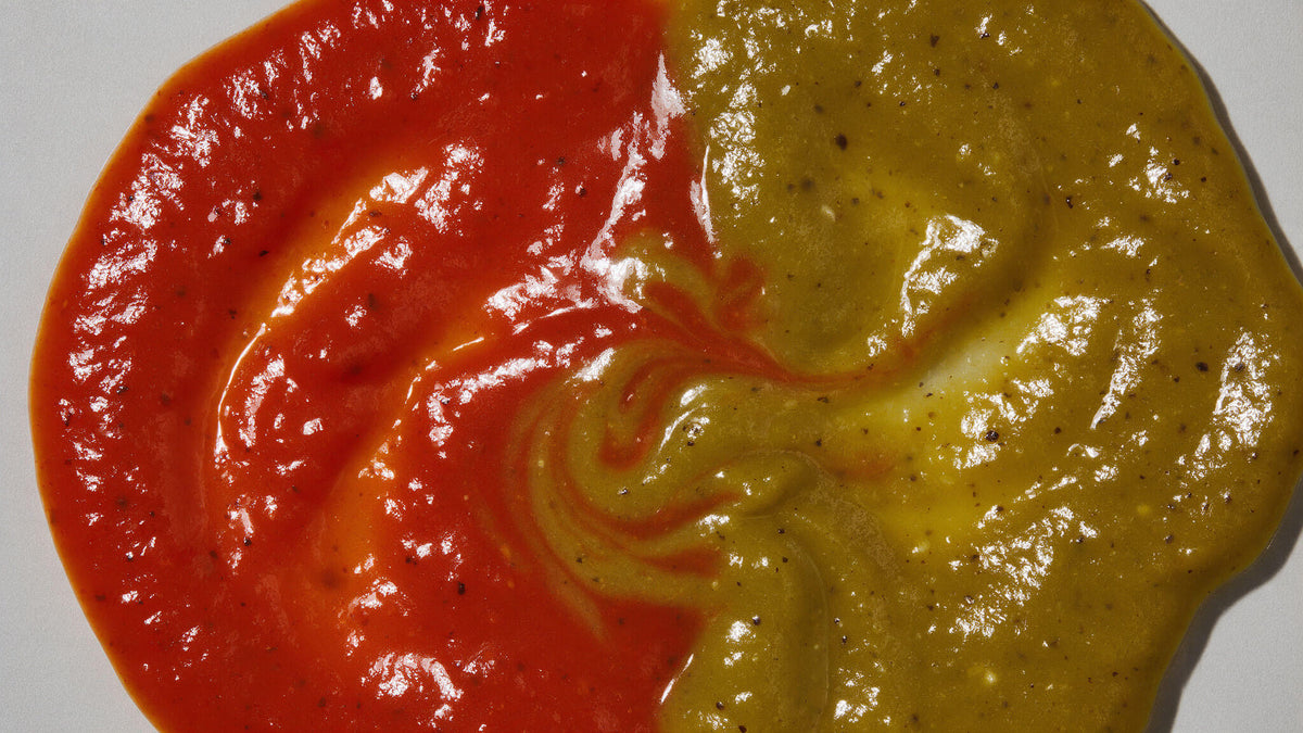 Overhead view of red Caribbean Style Habanero and green Fresh Serrano hot sauces side by side