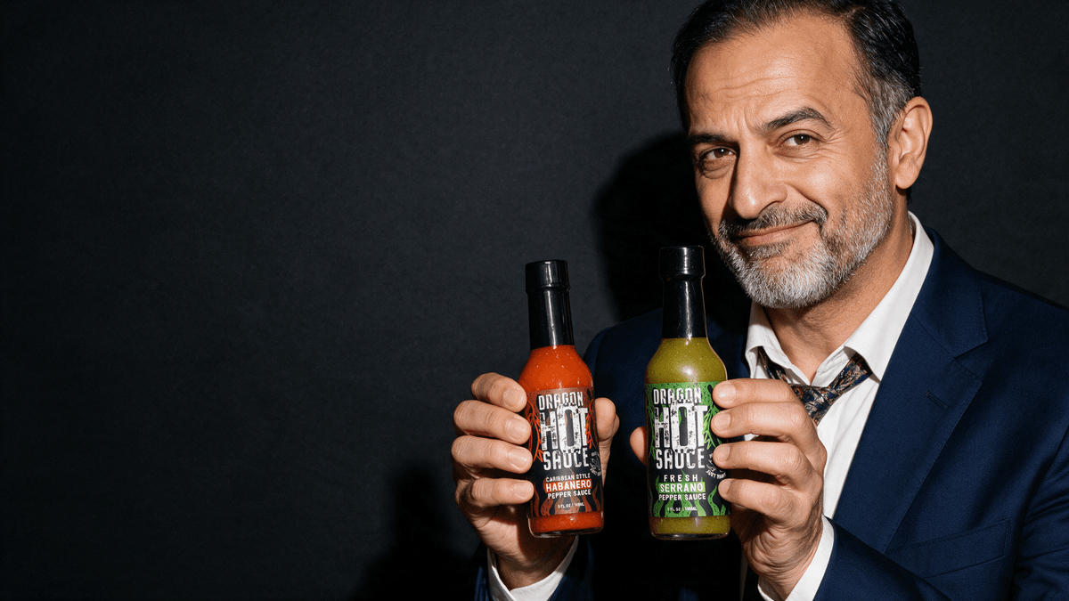 Man in a navy suit holding bottles of Dragon Caribbean Style Habanero and Fresh Serrano hot sauce
